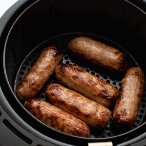 Sausages in an air fryer.