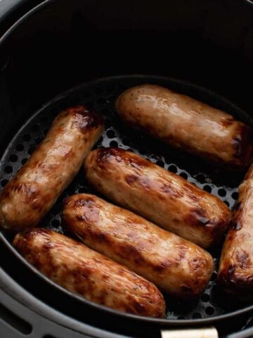 Sausages in an air fryer.