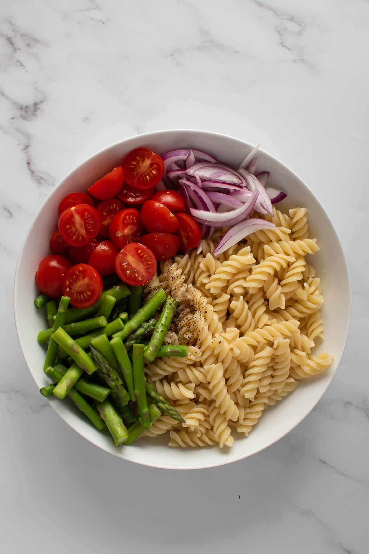 Asparagus Pasta Salad Ingredients in a bowl.