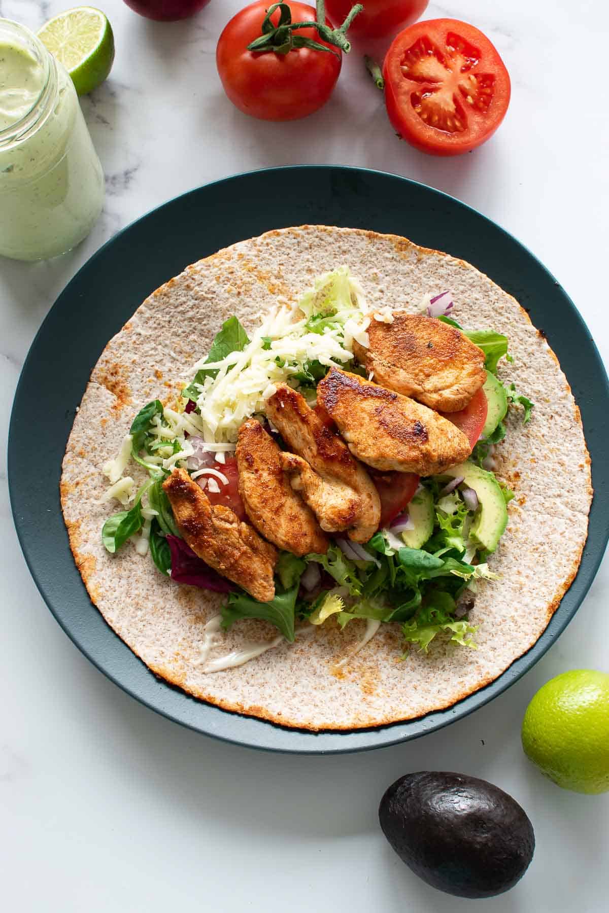 Wraps with avocado, chicken and tomato.