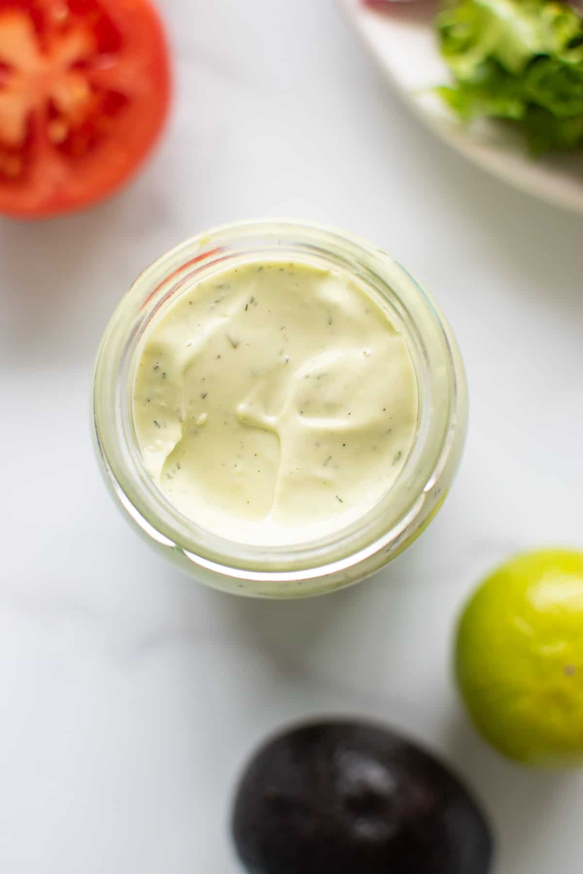Overhead view of the avocado ranch dip in a jar.