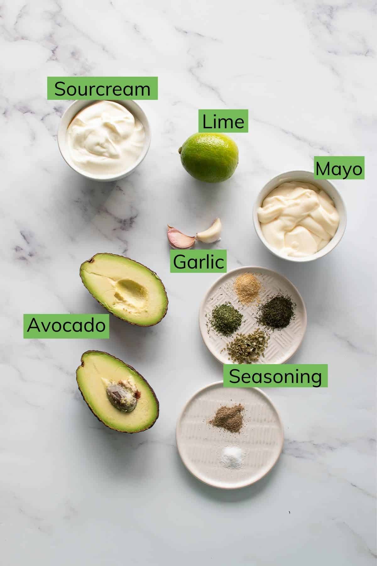 Ingredient required to make avocado ranch laid out on a table.