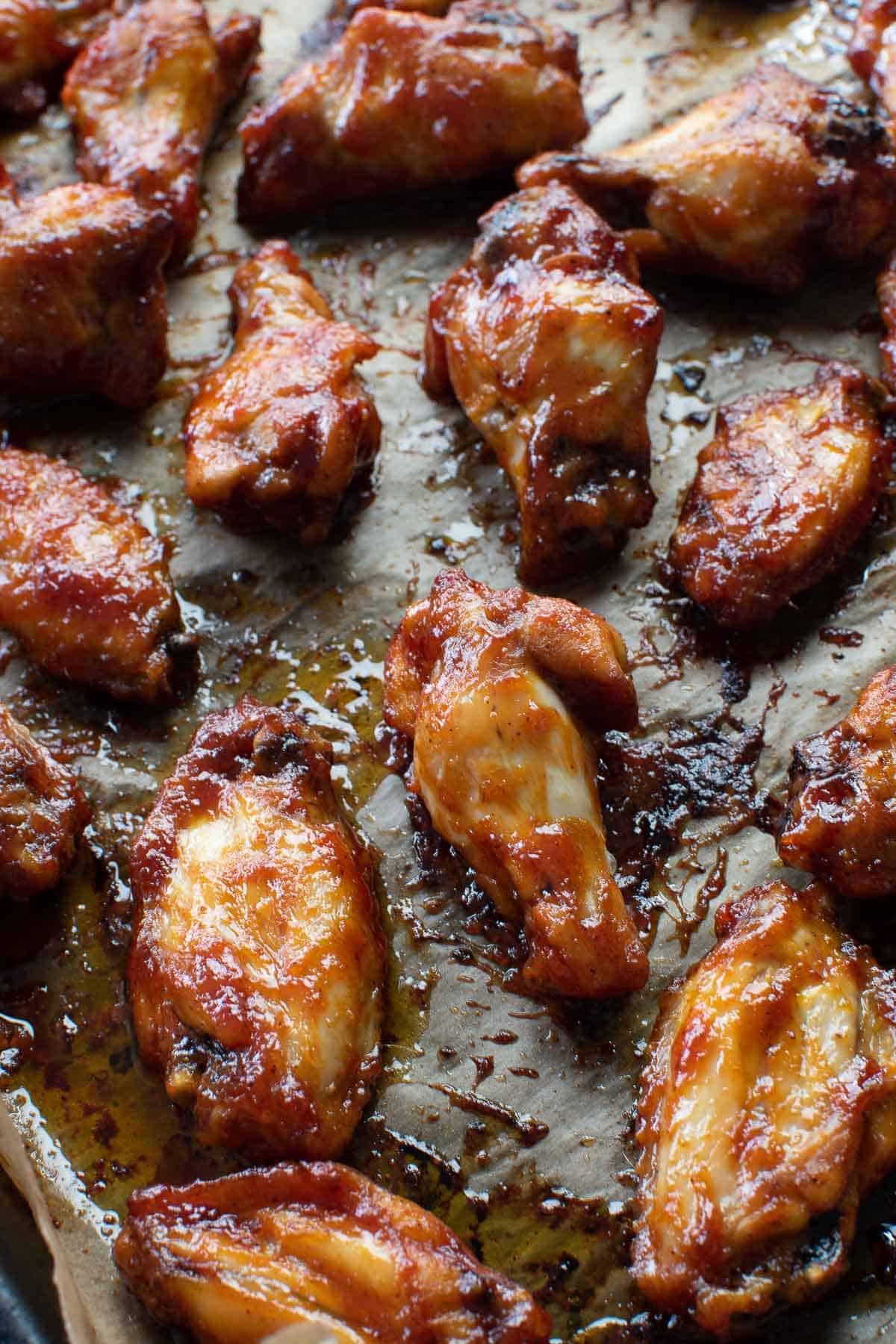 BBQ glazed wings on a baking sheet.