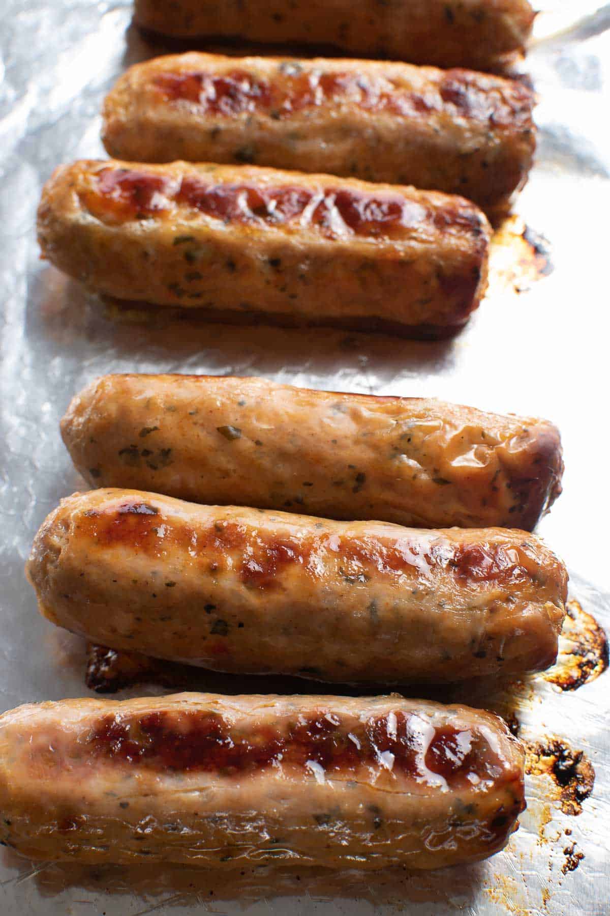 Baked sausages on a baking sheet.