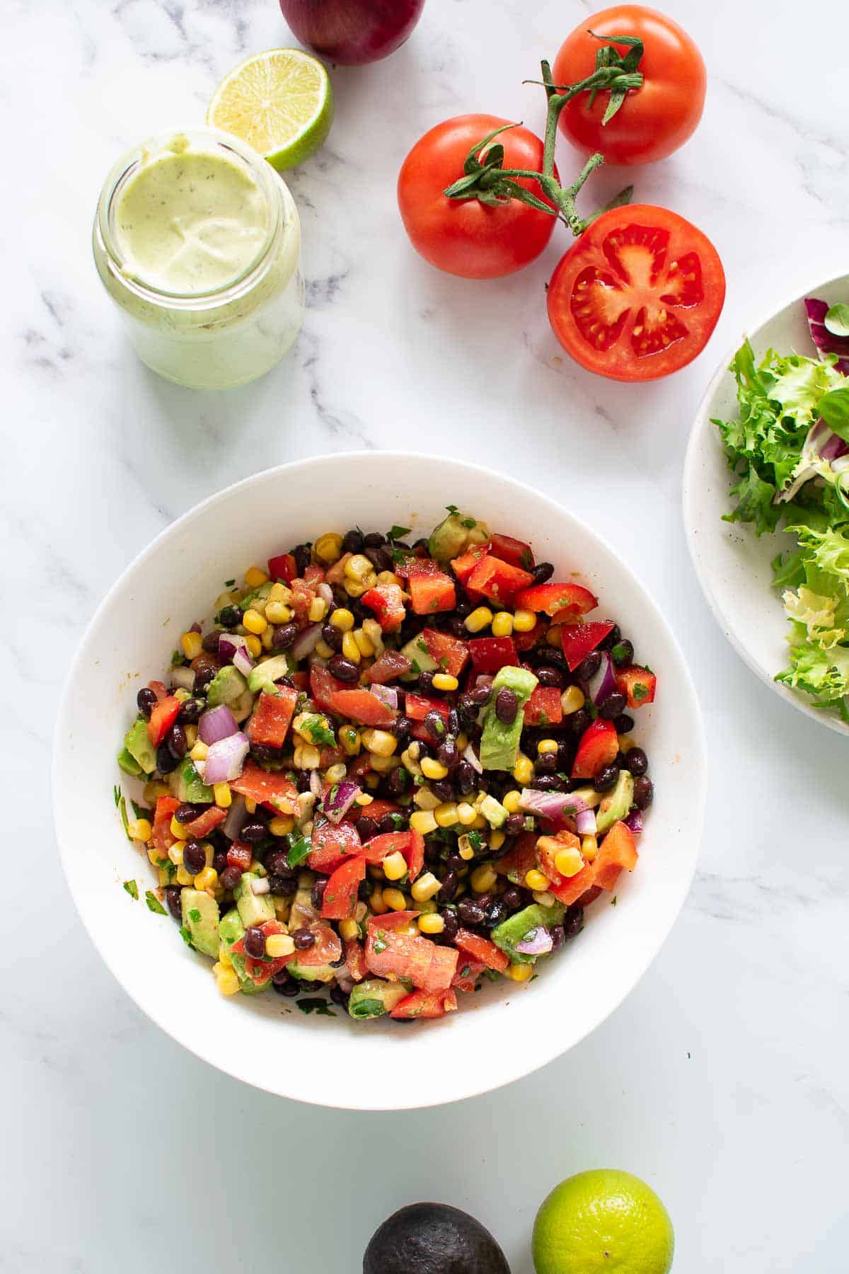 A bowl filled with Tex Mex corn avocado and black bean salad.