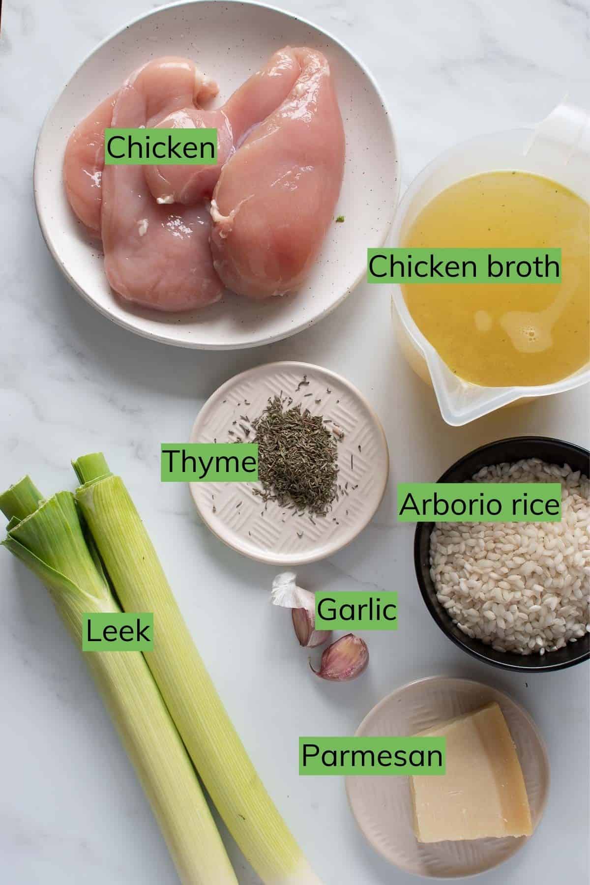 The ingredients needed for chicken and leek risotto laid out on a table.