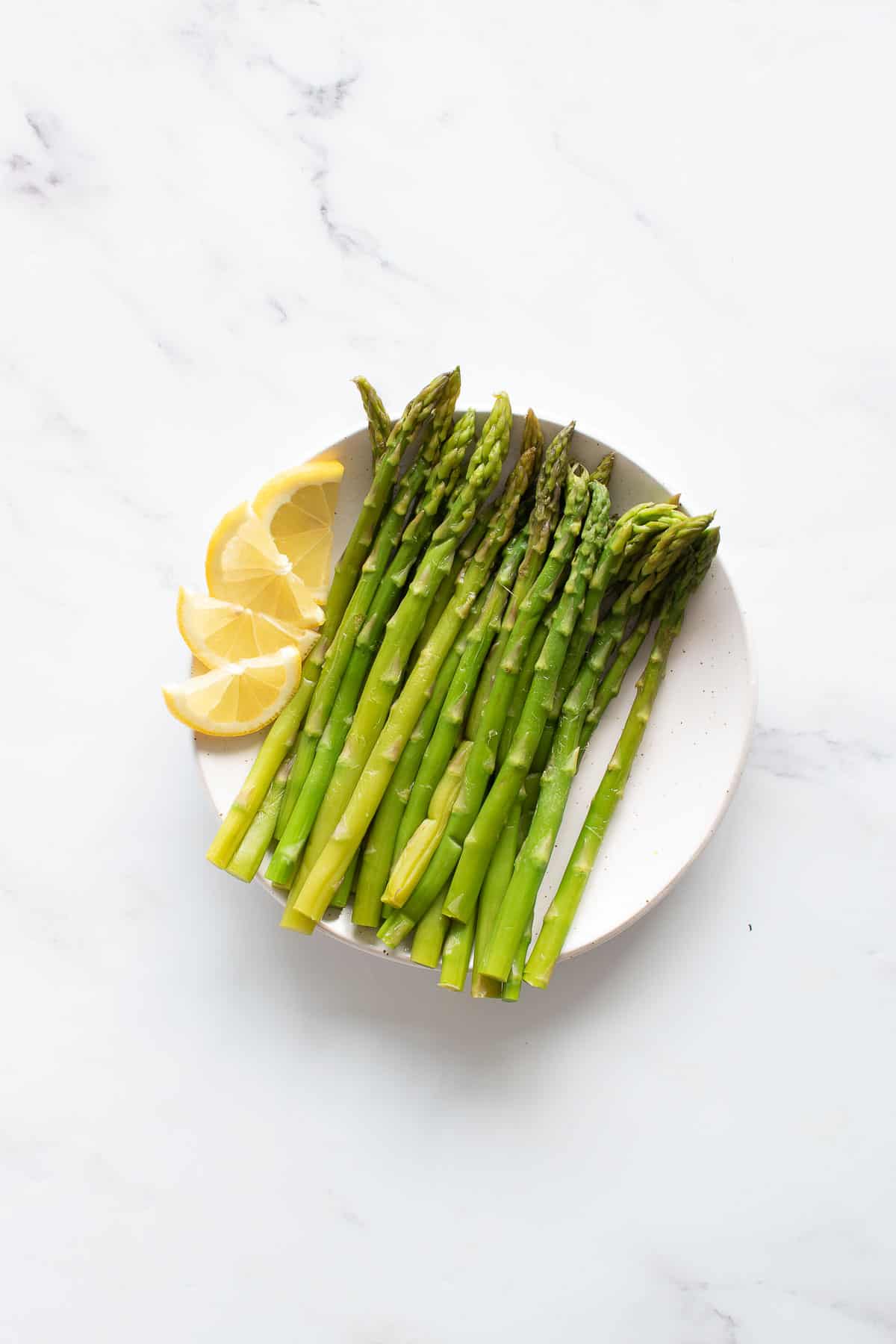 Pressure cooked asparagus on a plate.