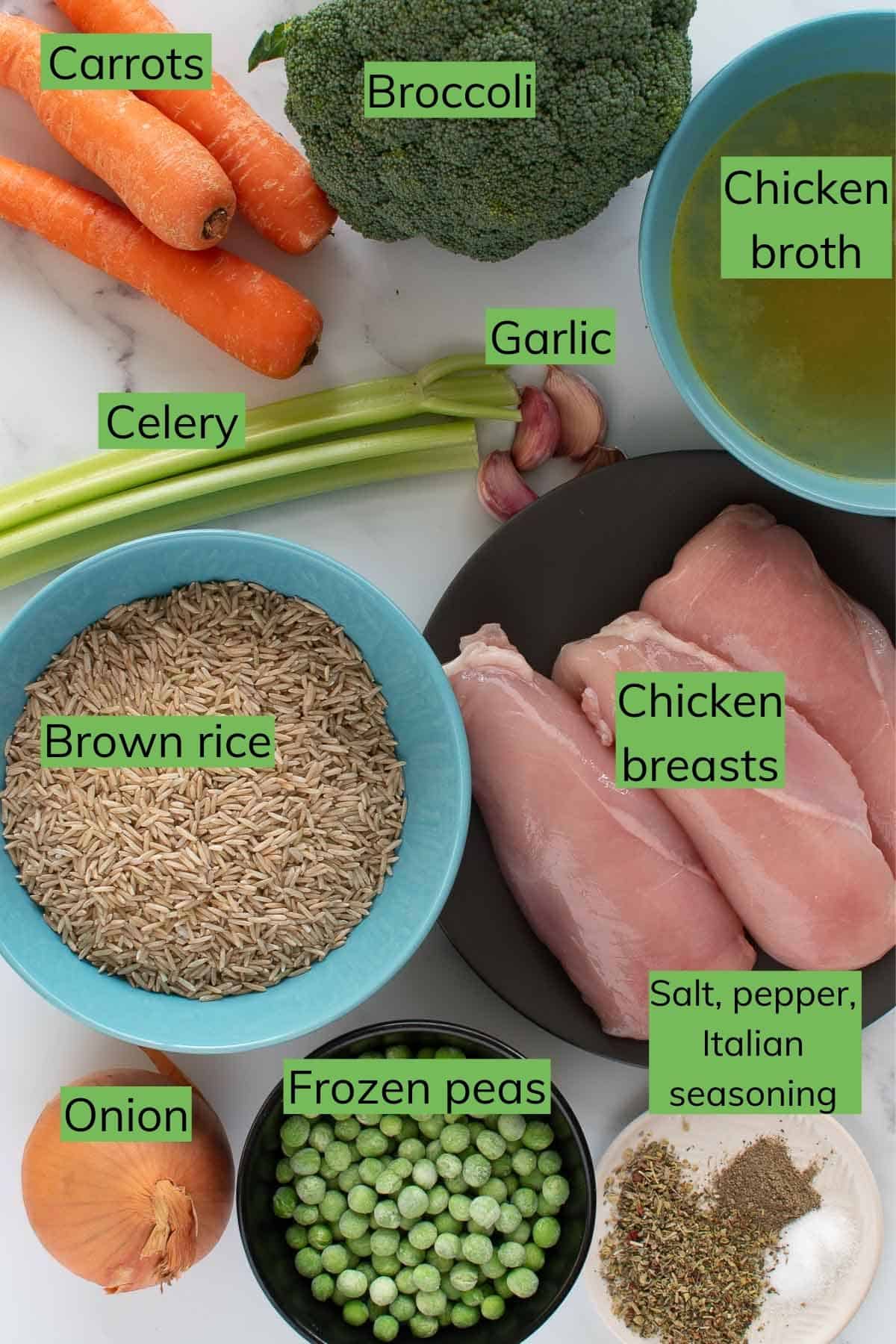 The ingredients required to make instant pot chicken and rice laid out on a table.