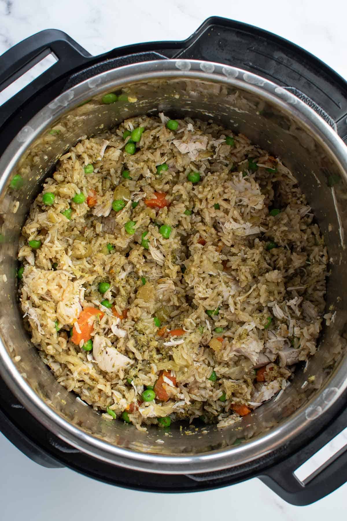 Instant pot with chicken, brown rice and vegetables.