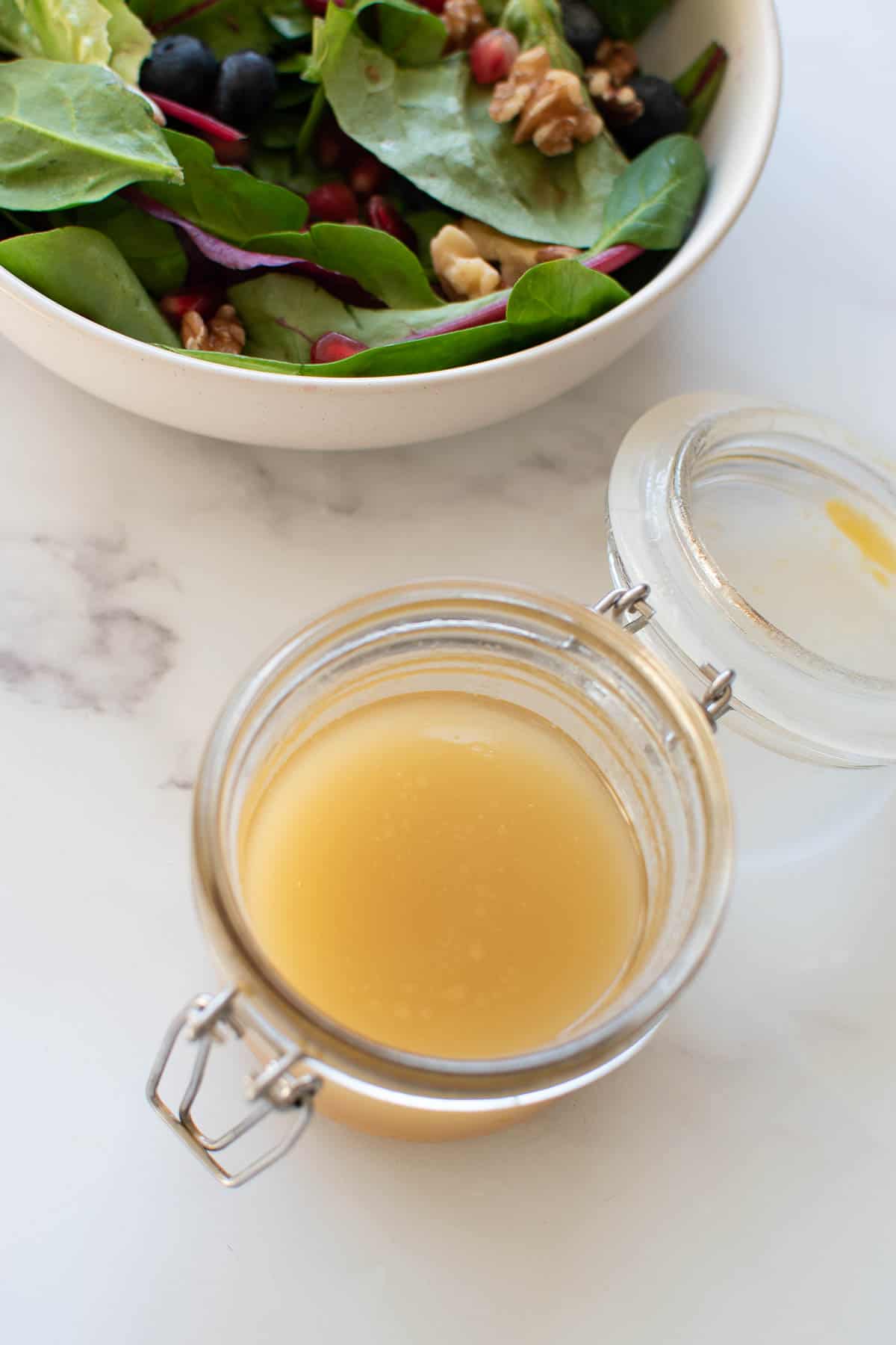 A bowl of maple syrup lemon vinaigrette.