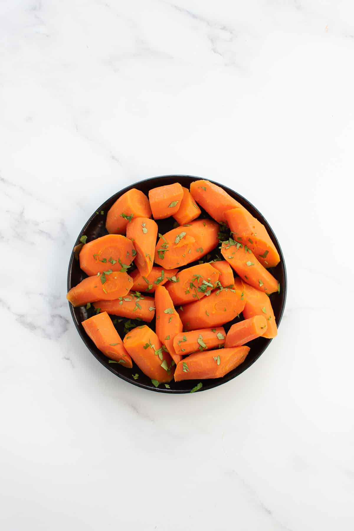 A plate full of carrots steamed in an instant pot.