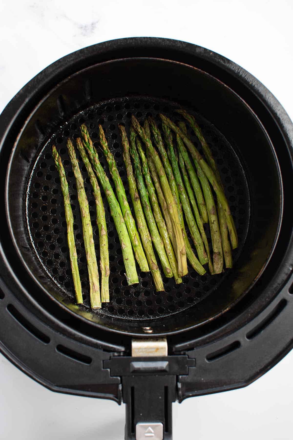 Roasted asparagus in an air fryer.