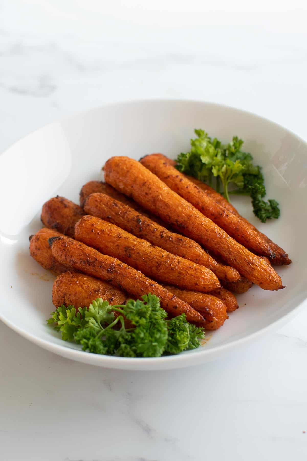 A bowl of spicy roasted carrots.