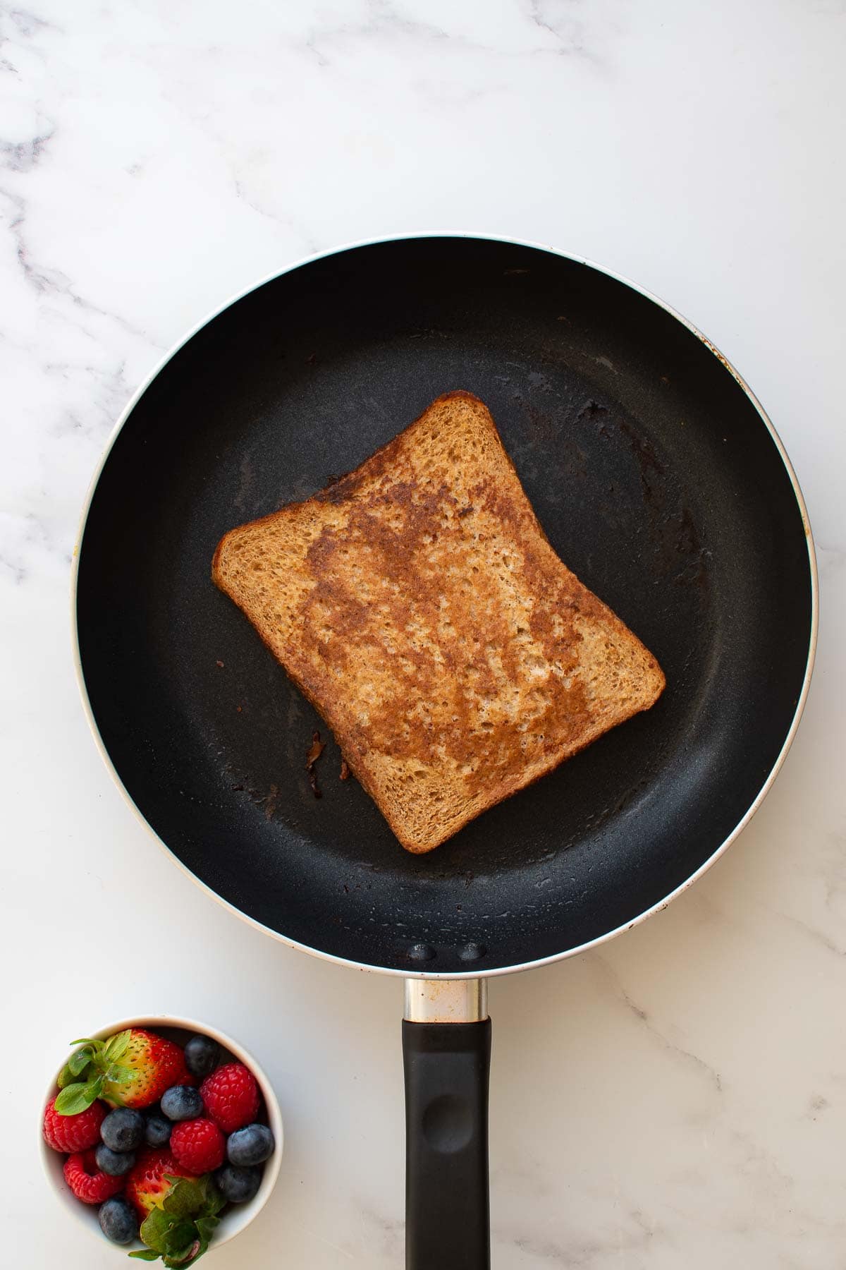 French toast being cooked in a skillet.