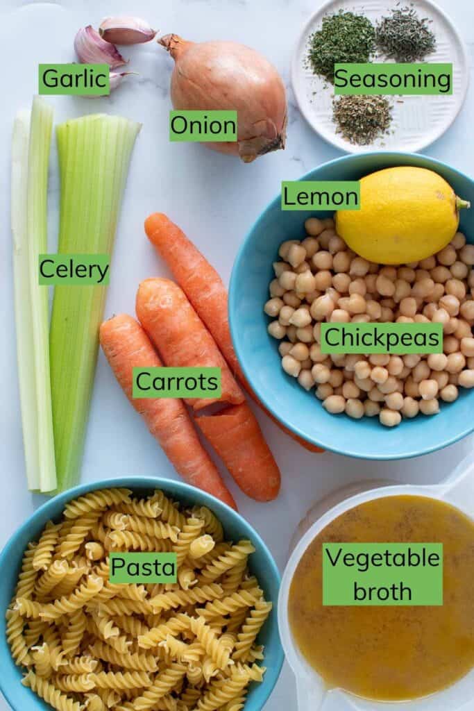 The ingredients needed to make chickpea noodle soup laid out on a table.