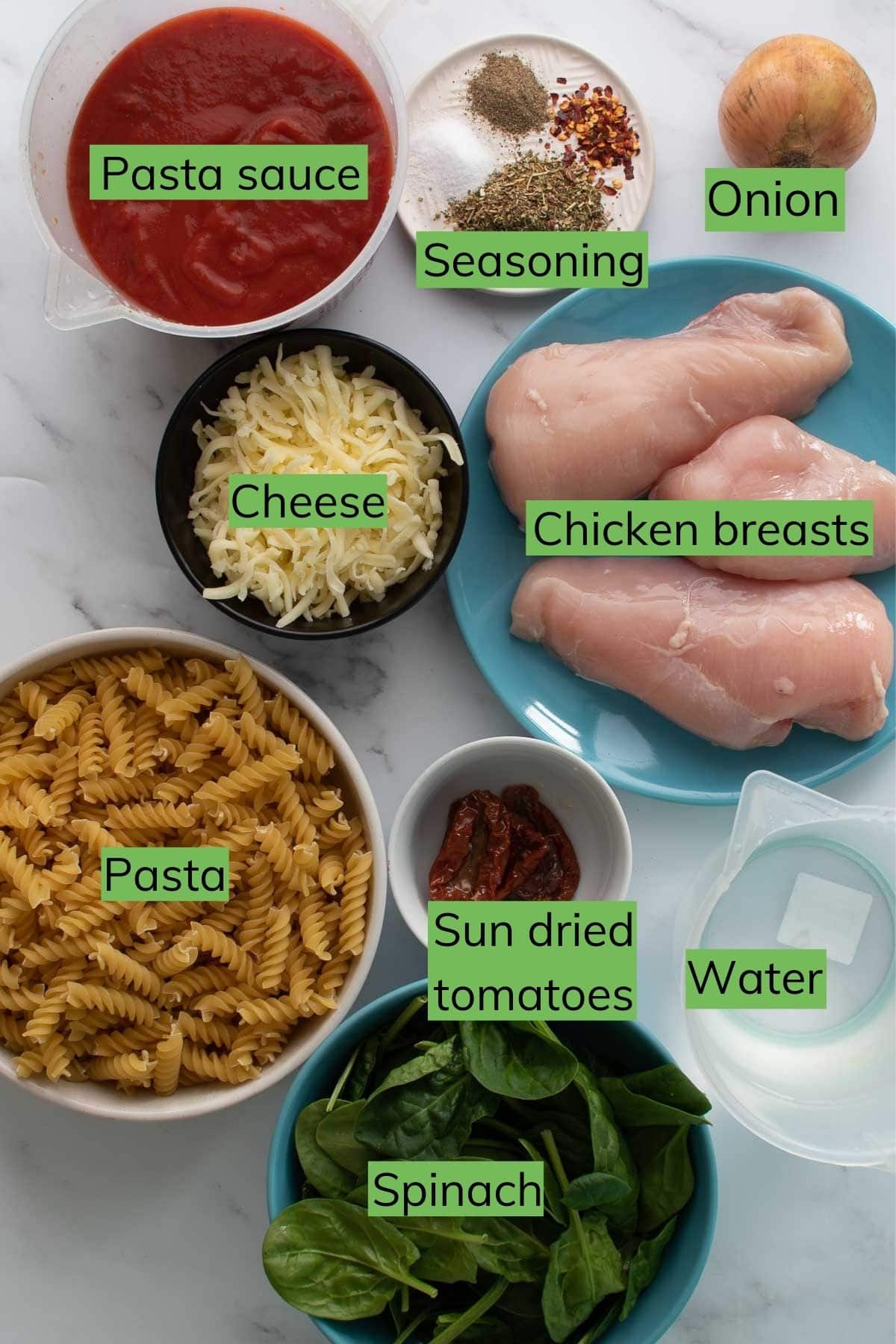 The ingredients needed to make Instant Pot chicken pasta laid out on a table.