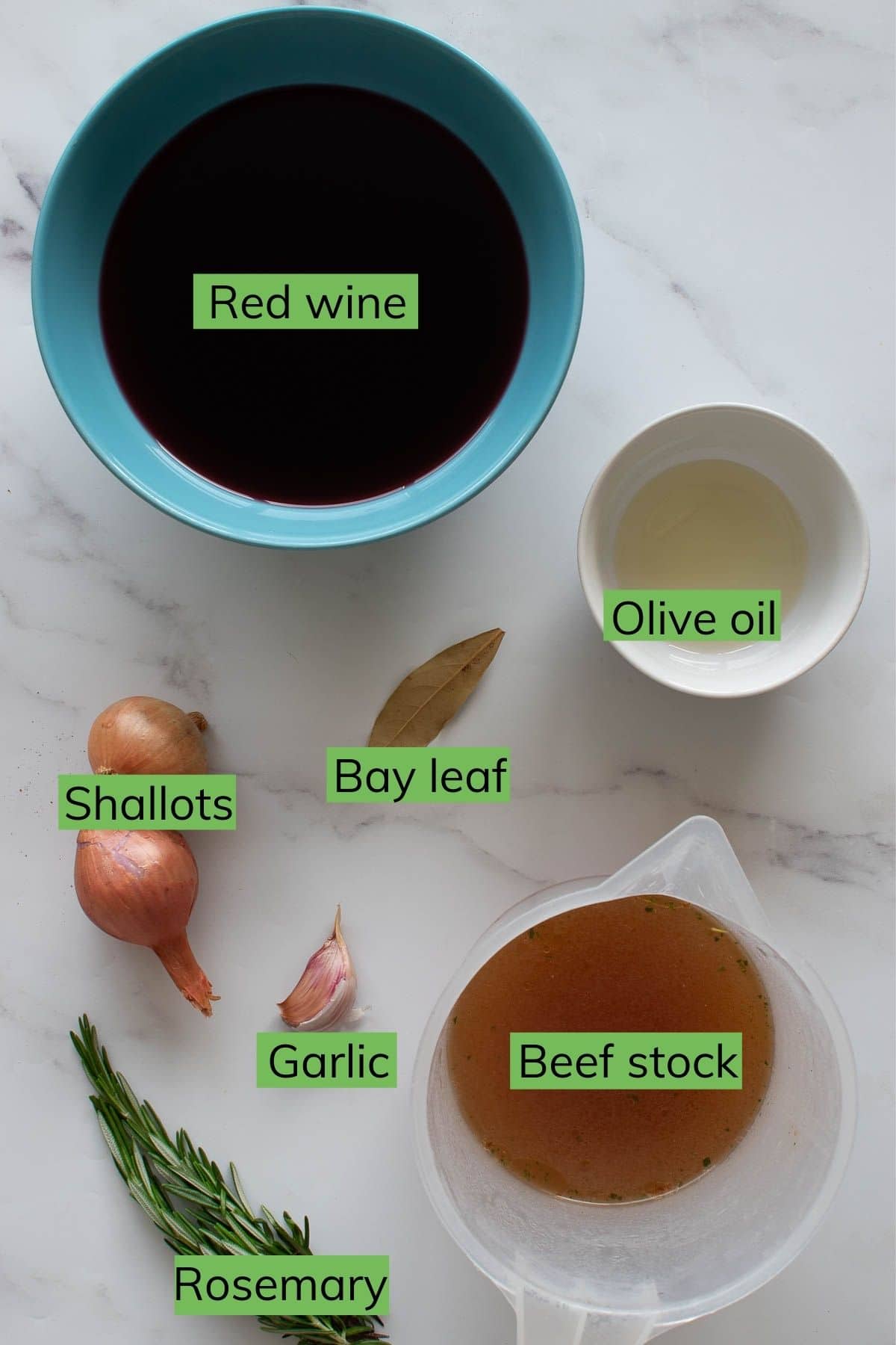 The ingredients for red wine jus laid out on a table.