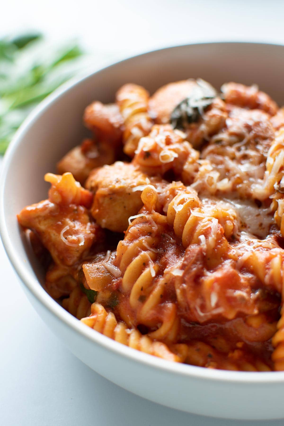 Close up of a bowl of chicken and pasta.