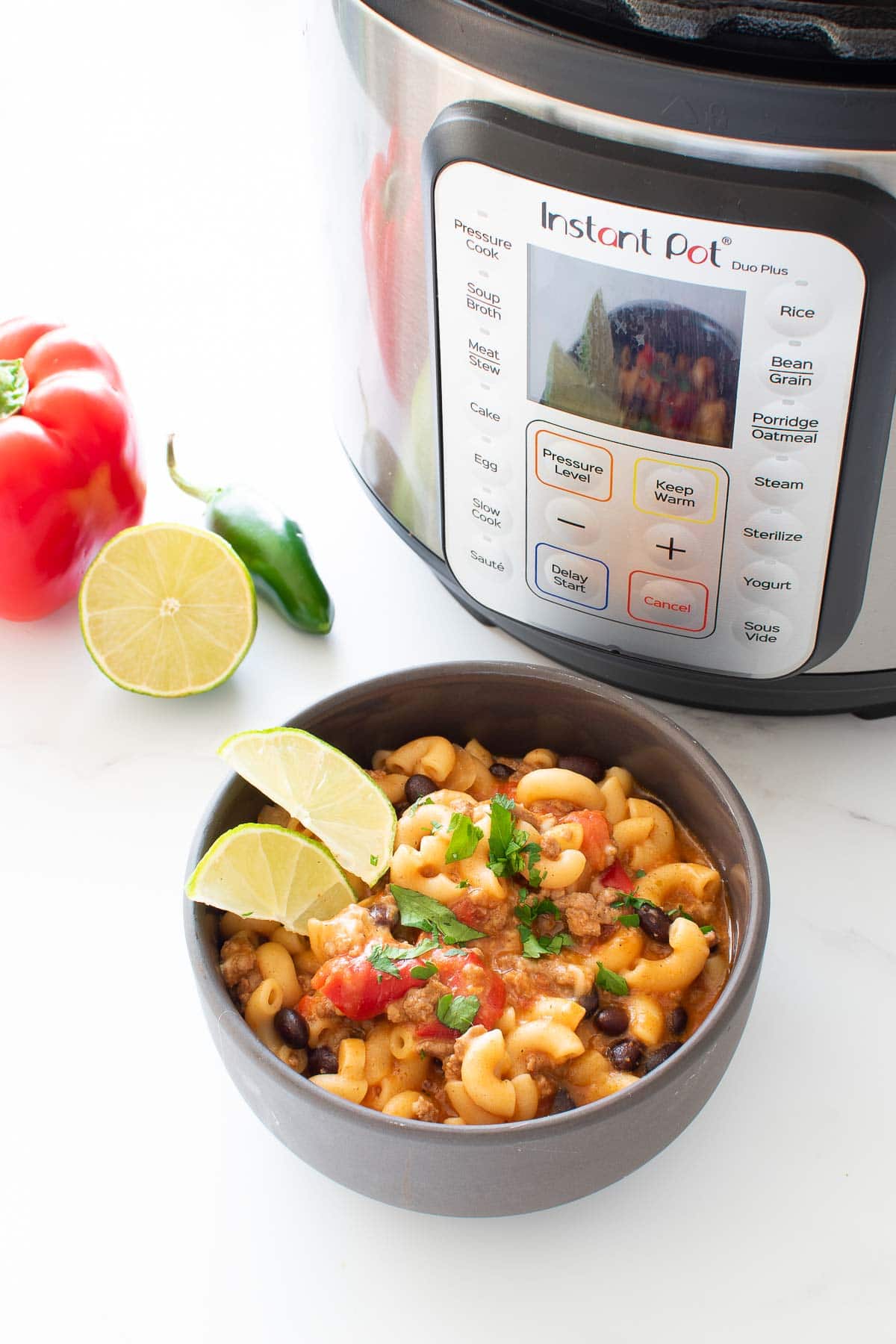 A bowl of chili mac, with an Instant Pot in the background.