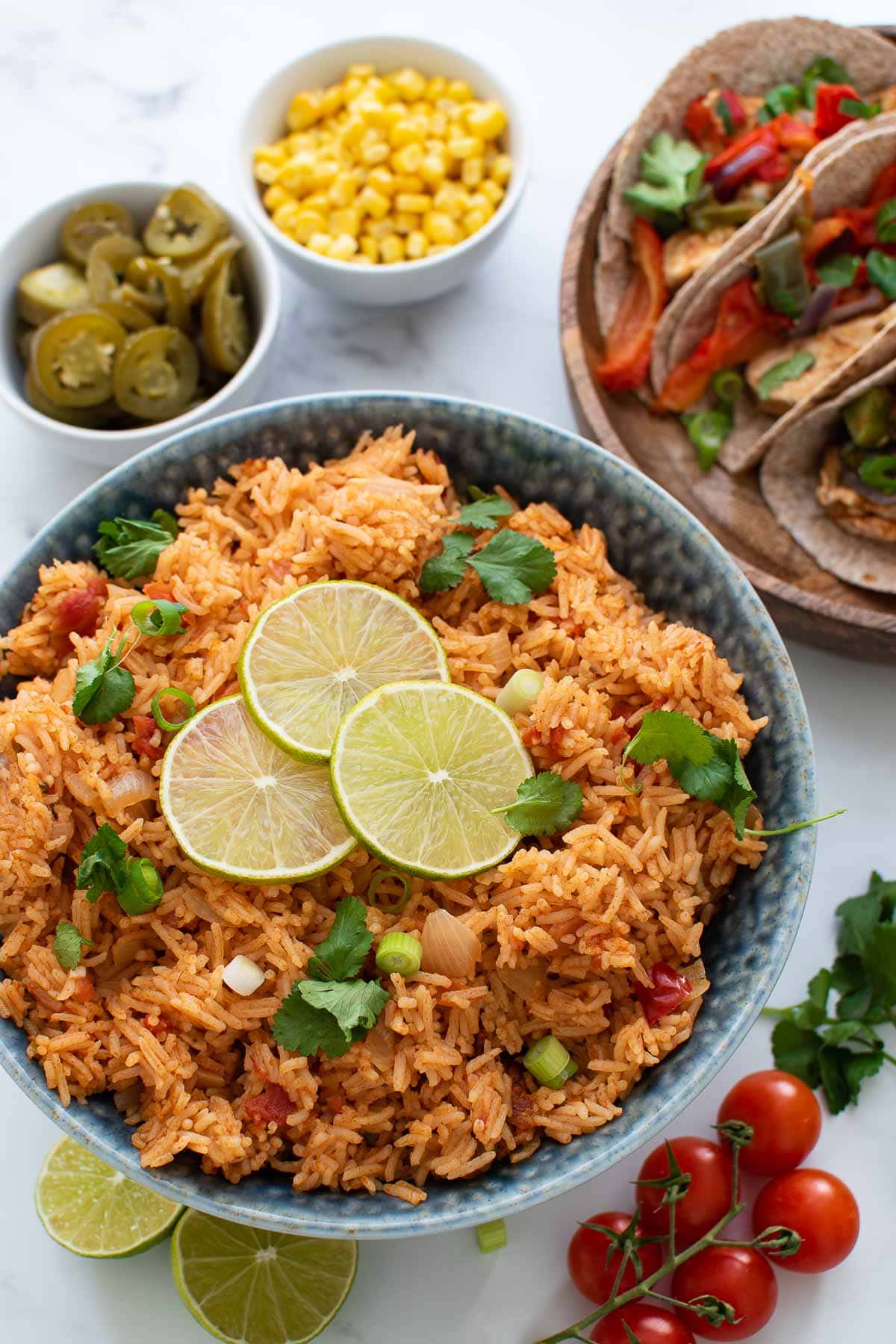 A bowl of Mexican rice garnished with lime and cilantro.