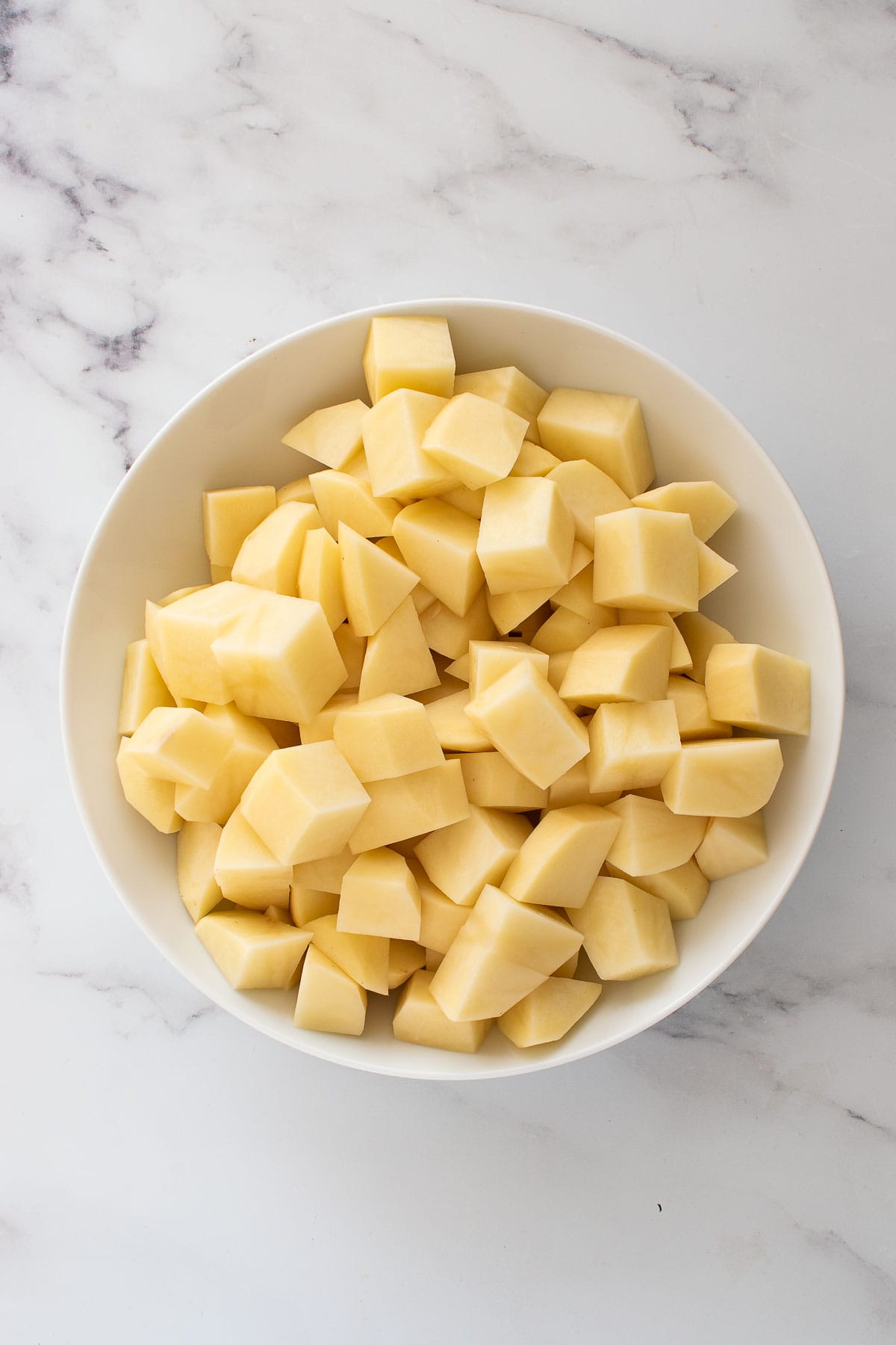 Cubed potatoes in a bowl.