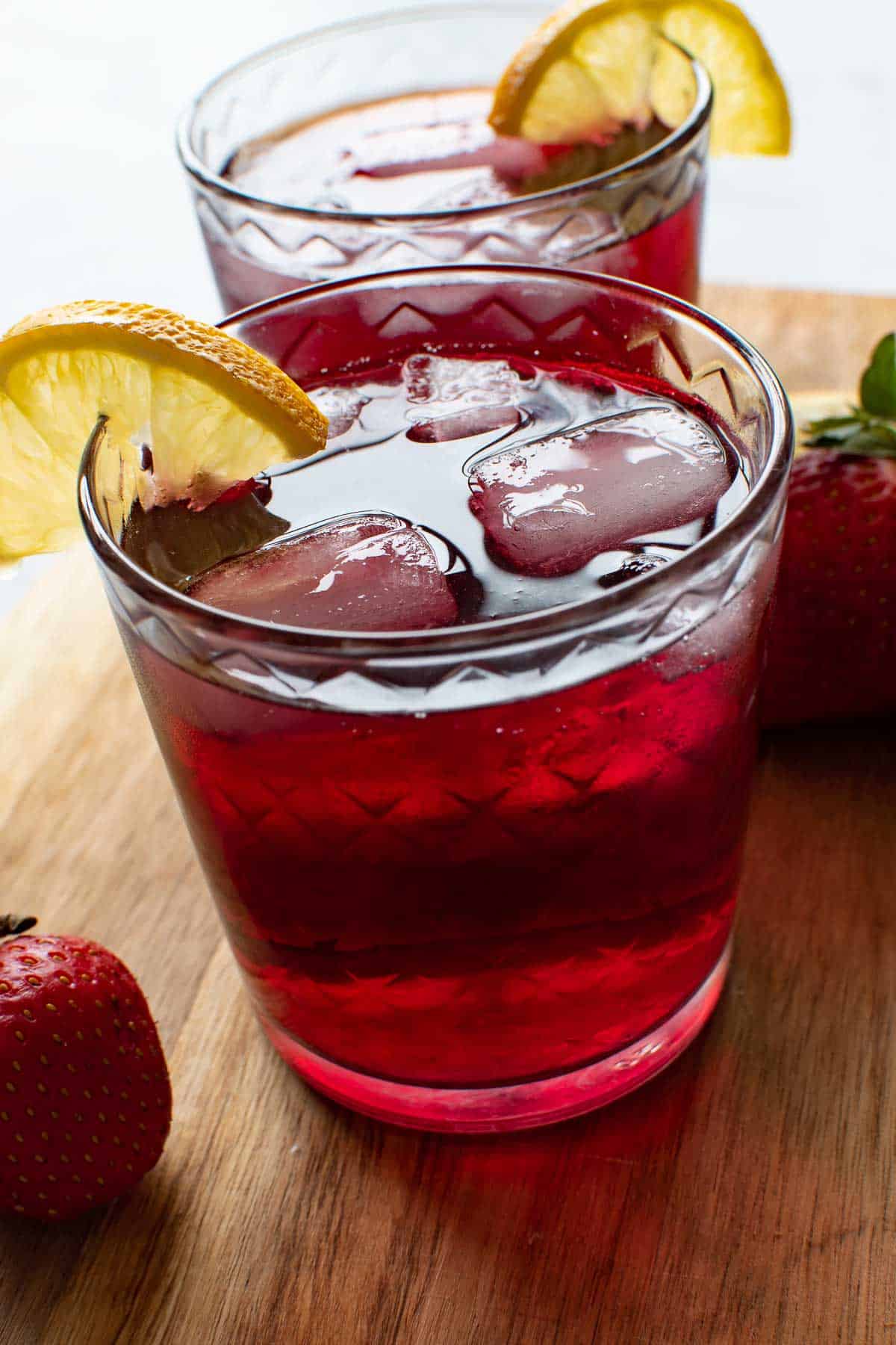 Red wine summer cocktails on a wooden board.