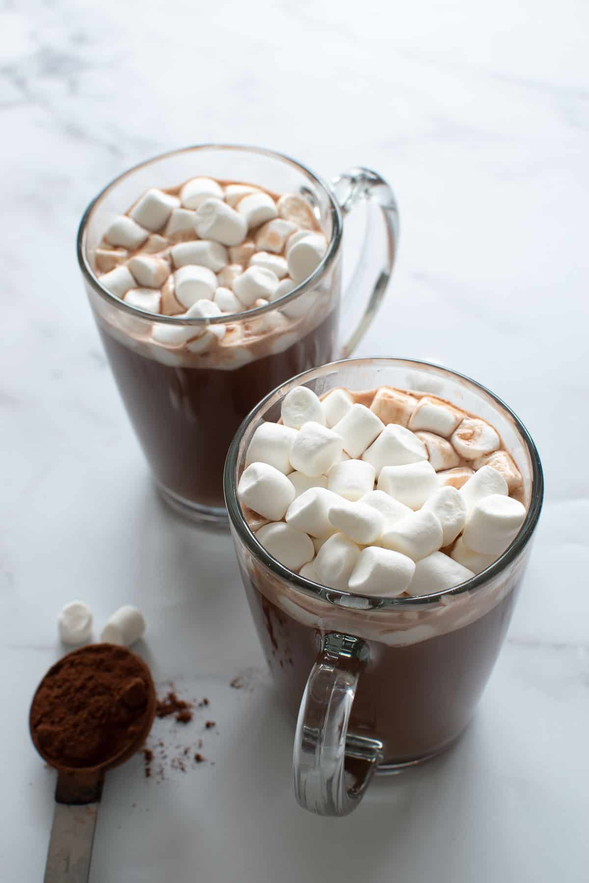 Two glasses of hot chocolate with marshmallows.