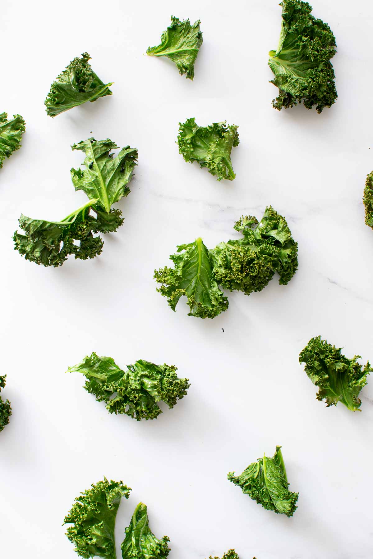 Kale chips scattered on a table.