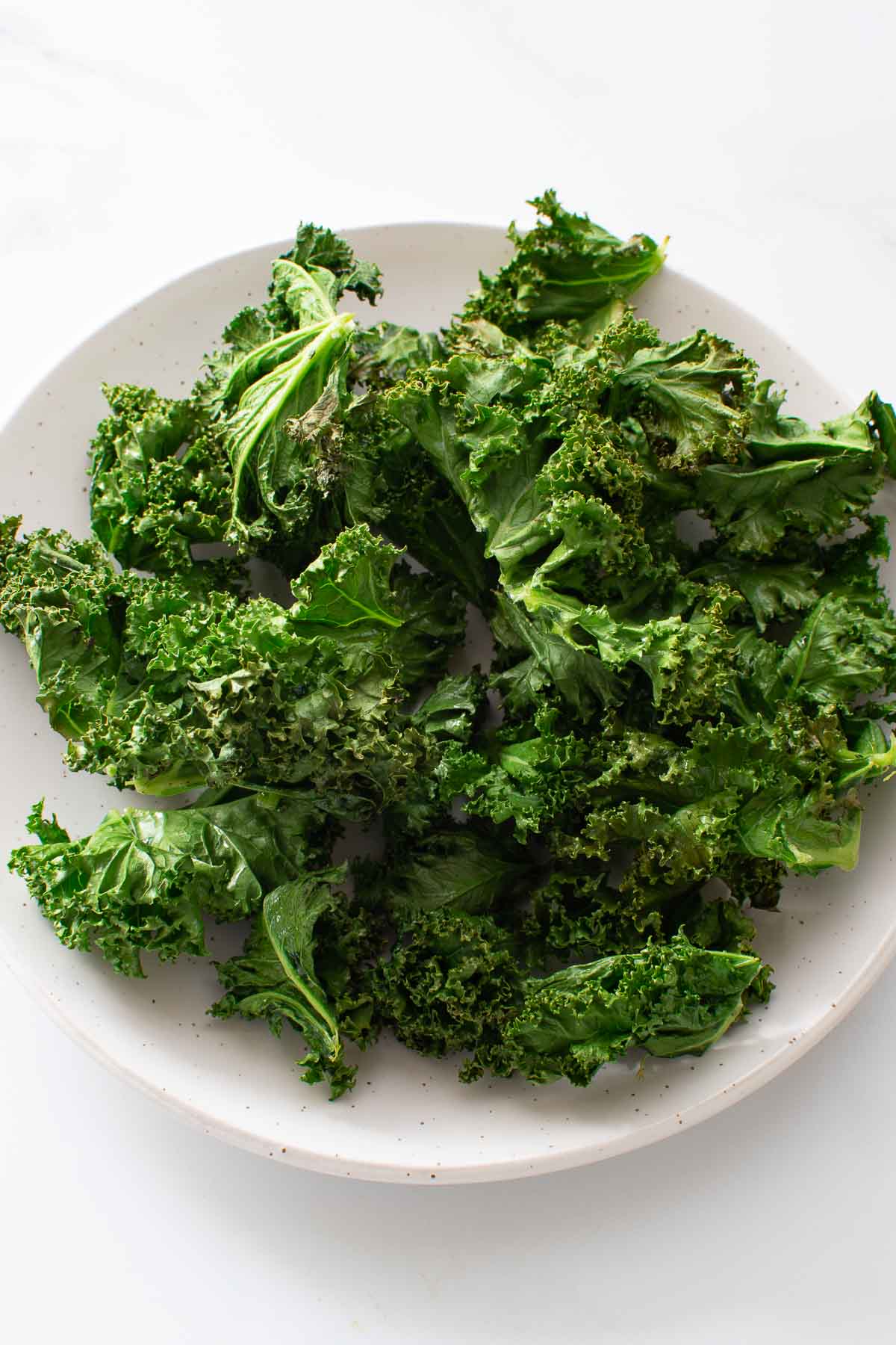 Close up of a plate of kale chips.