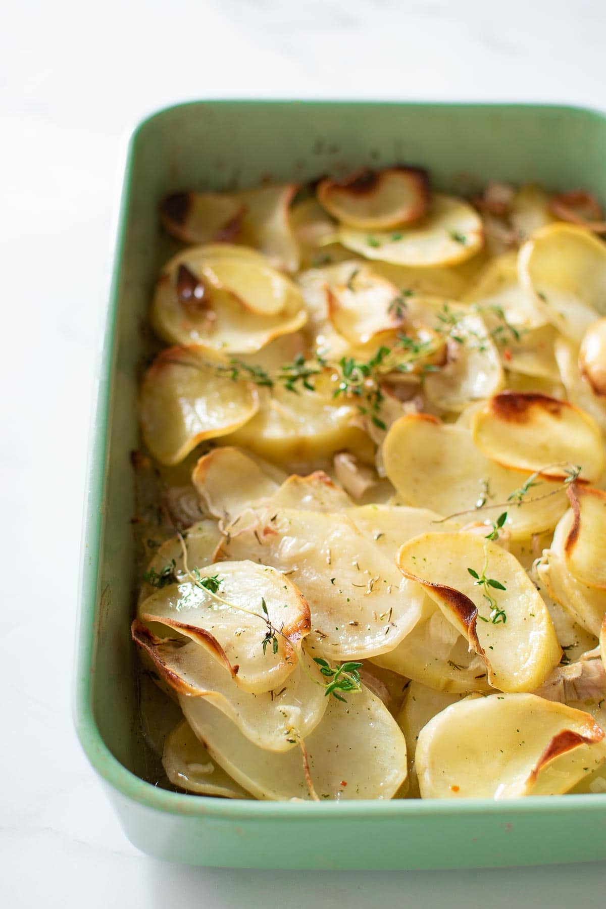 Boulangere potatoes in a casserole dish.