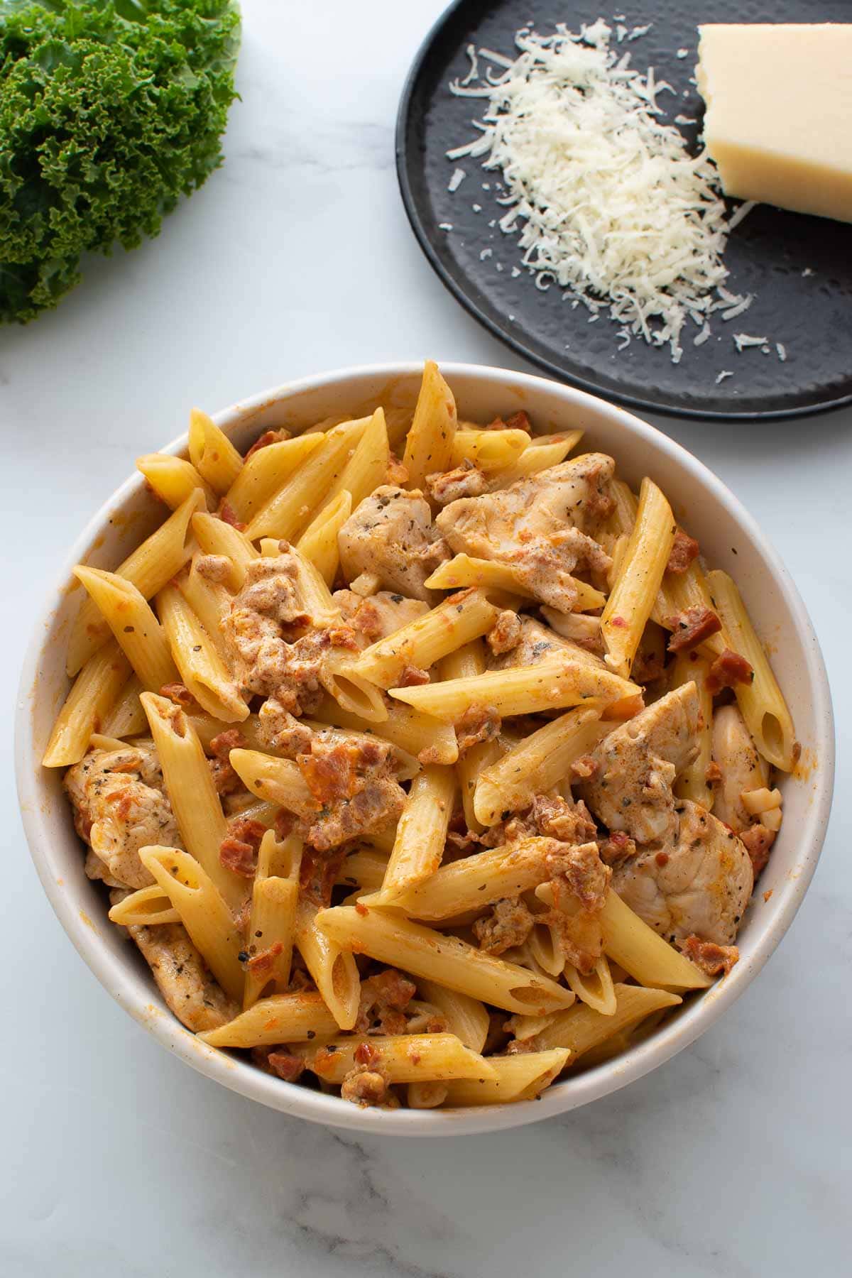 Close up of a bowl of pasta with chicken and chorizo.