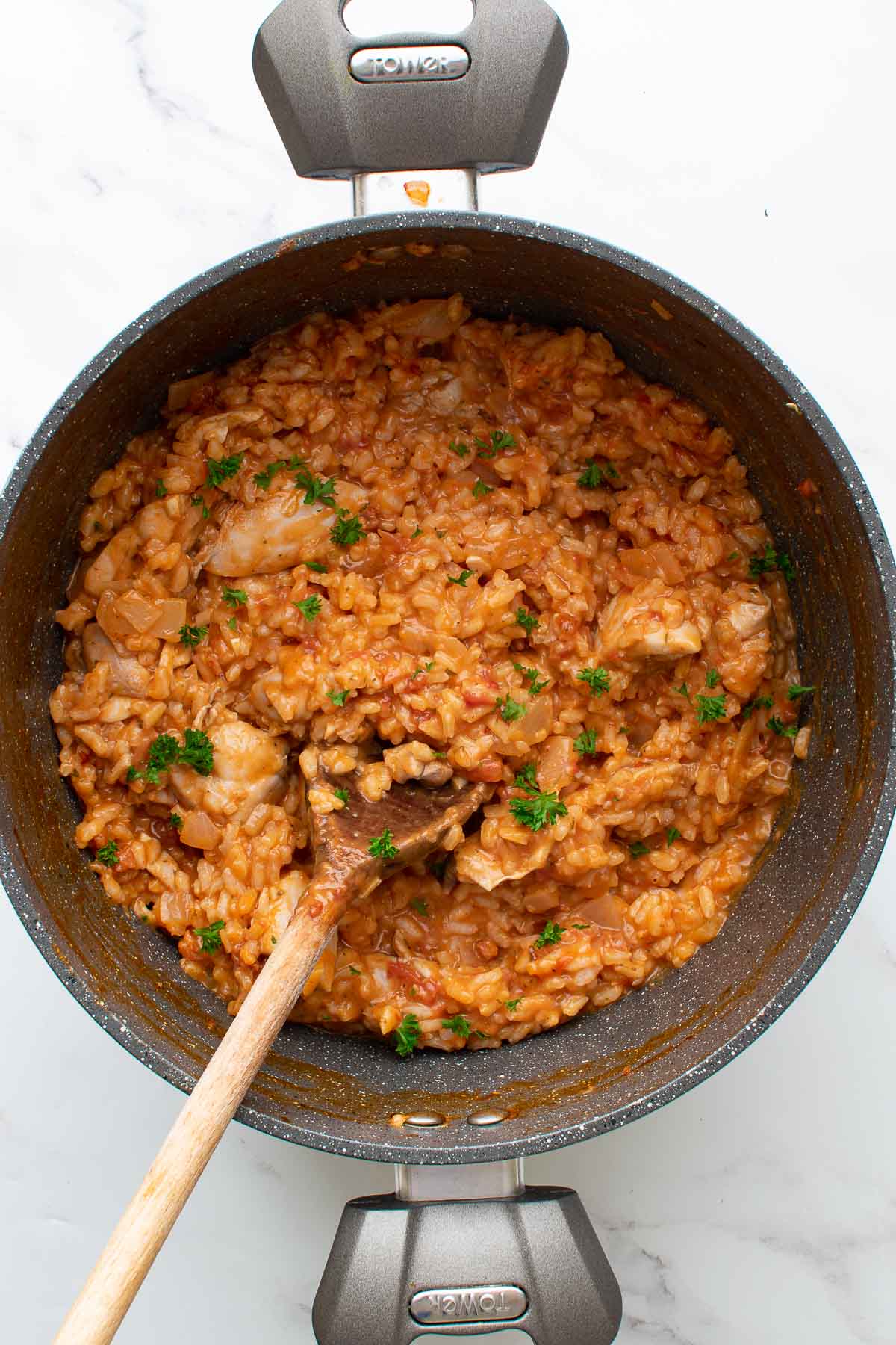 A large pot with creamy chicken chorizo risotto with Parmesan.