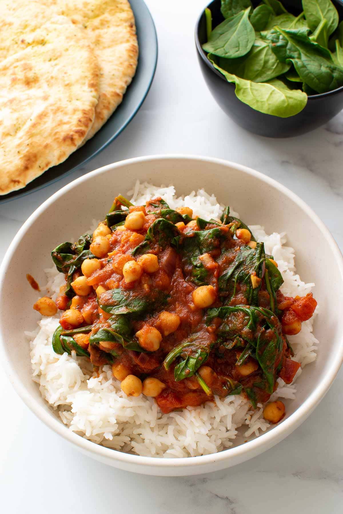 Chickpea and spinach curry in a bowl with rice.