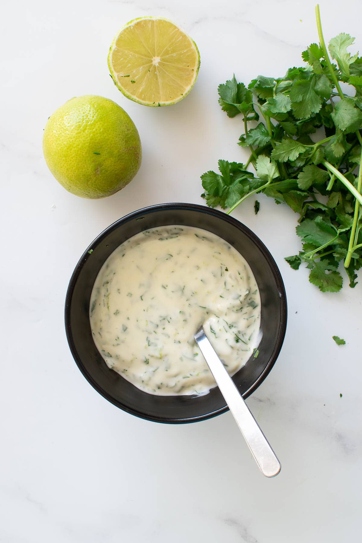 Cilantro lime aioli with cilantro and lime on the side.