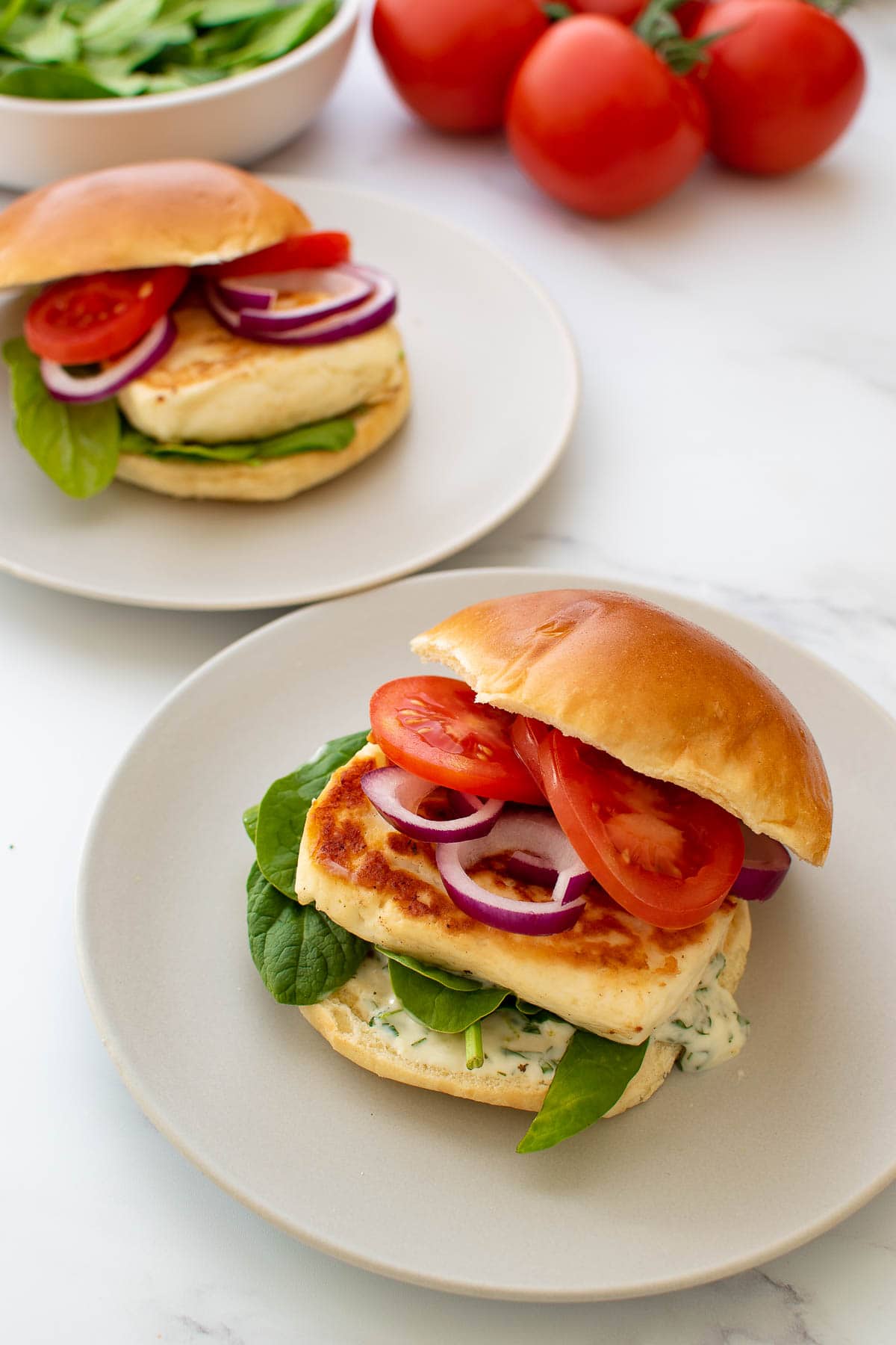 Halloumi burgers on plates.