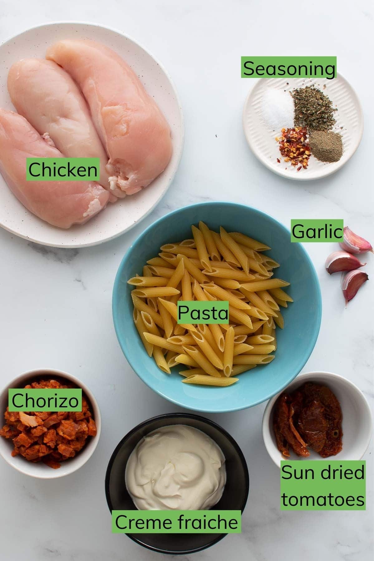 Ingredients needed to make chicken and chorizo pasta.