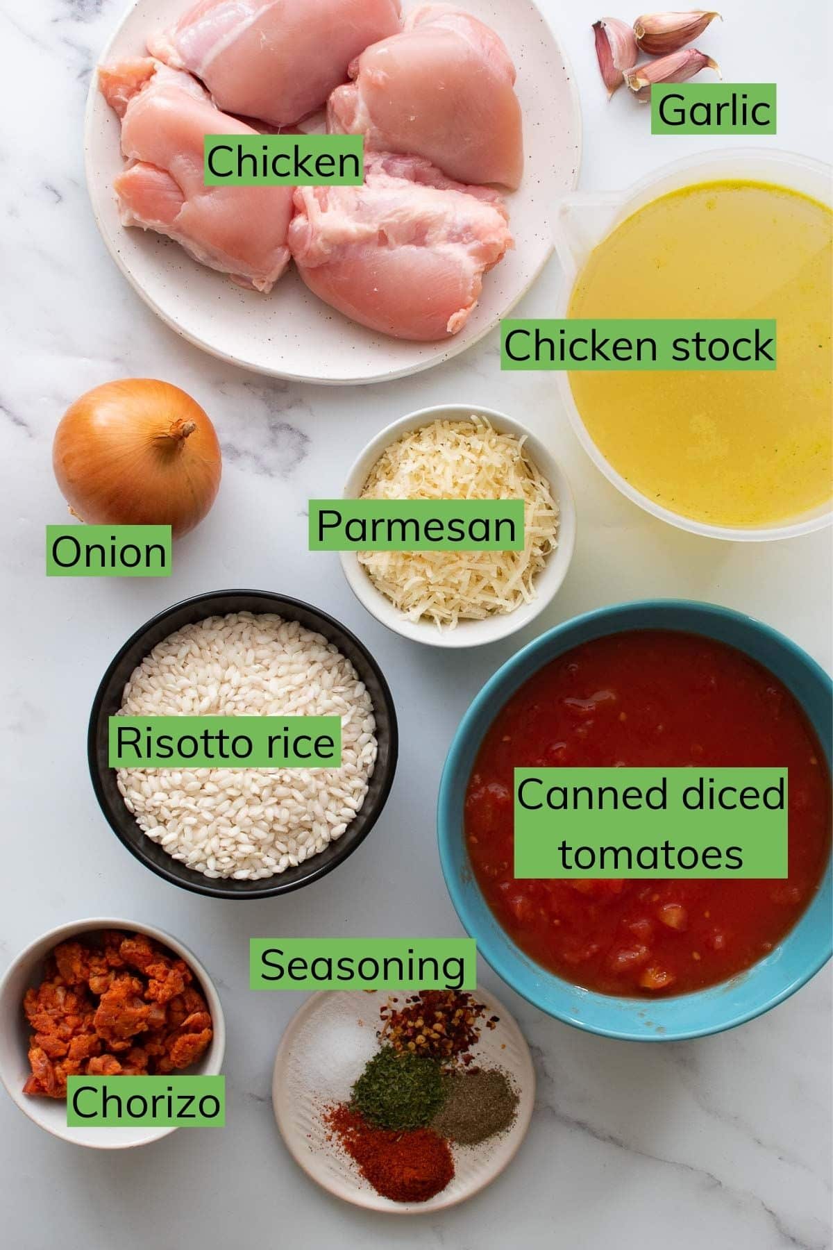 The ingredients needed to make chicken and chorizo risotto laid out on a table.