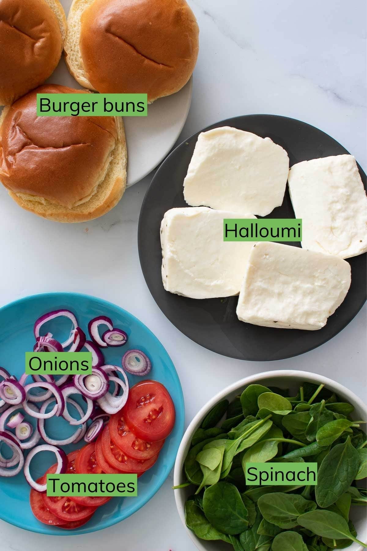 The ingredients needed to make halloumi burgers laid out on a table.