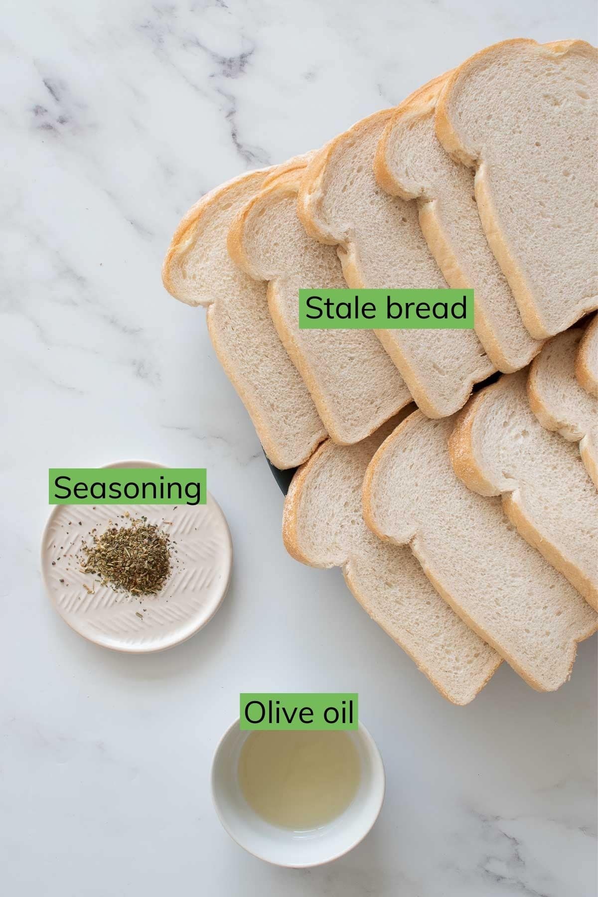 Stale bread, seasoning and olive oil on a table.