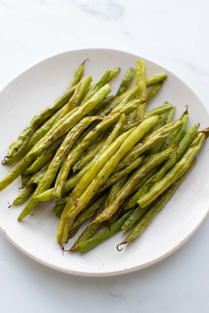 A plate with roasted green beans.