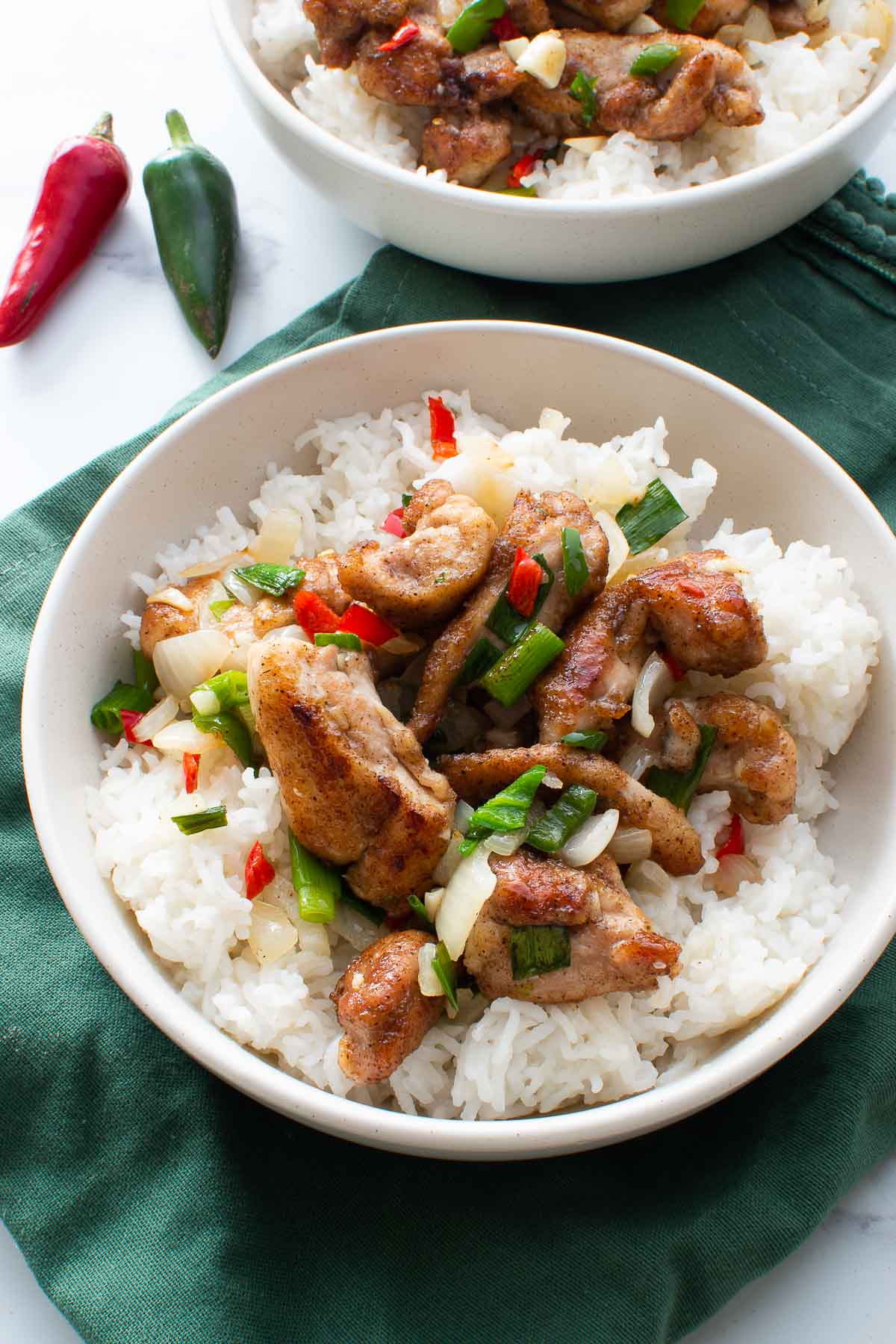 Salt and pepper chicken thighs with rice.