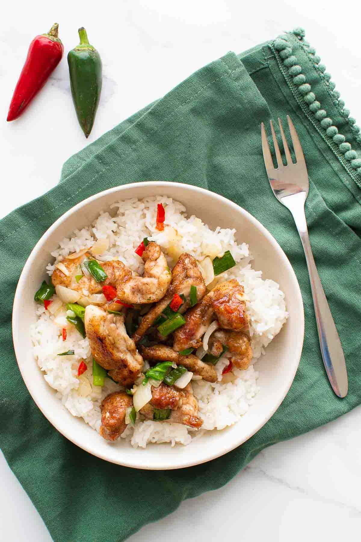 Salt and chili chicken in a bowl with rice.