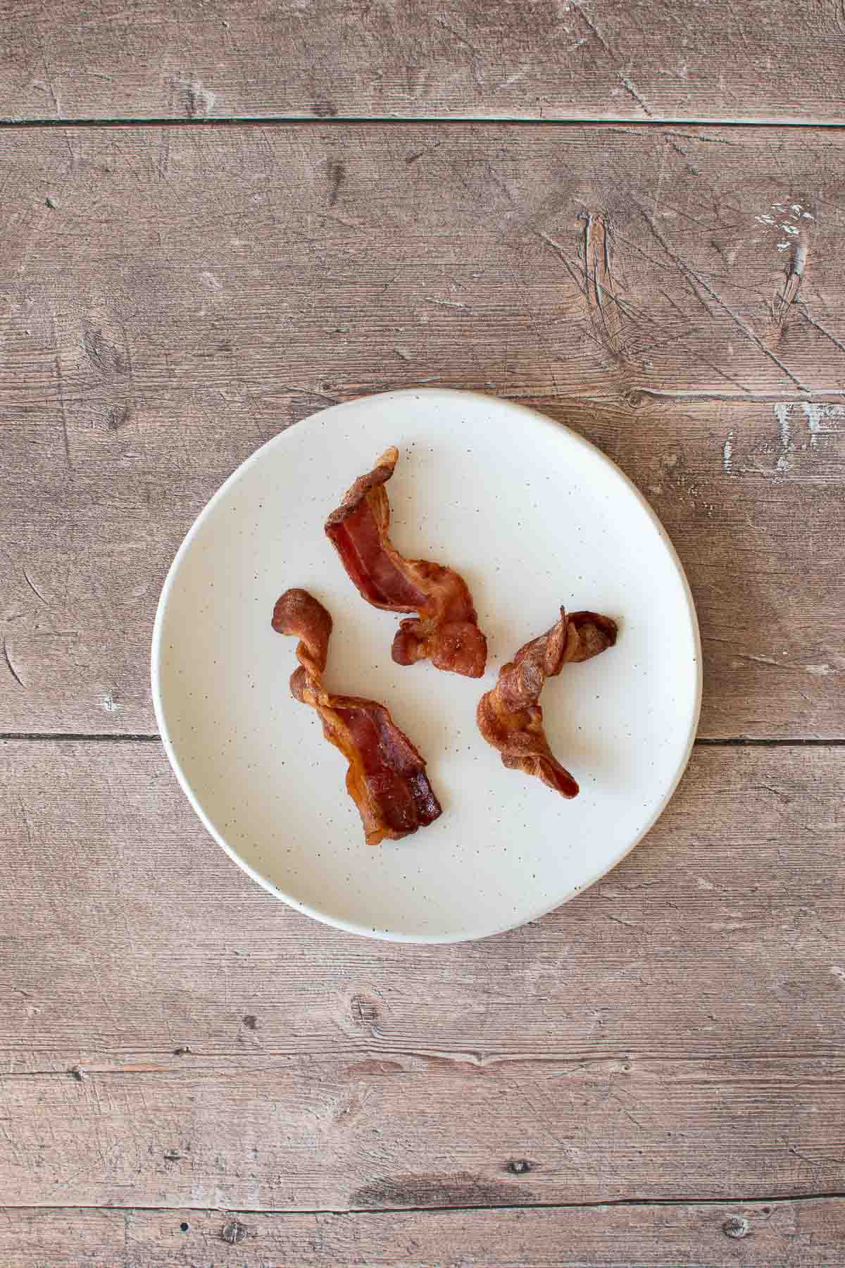 Cooked bacon on a plate.