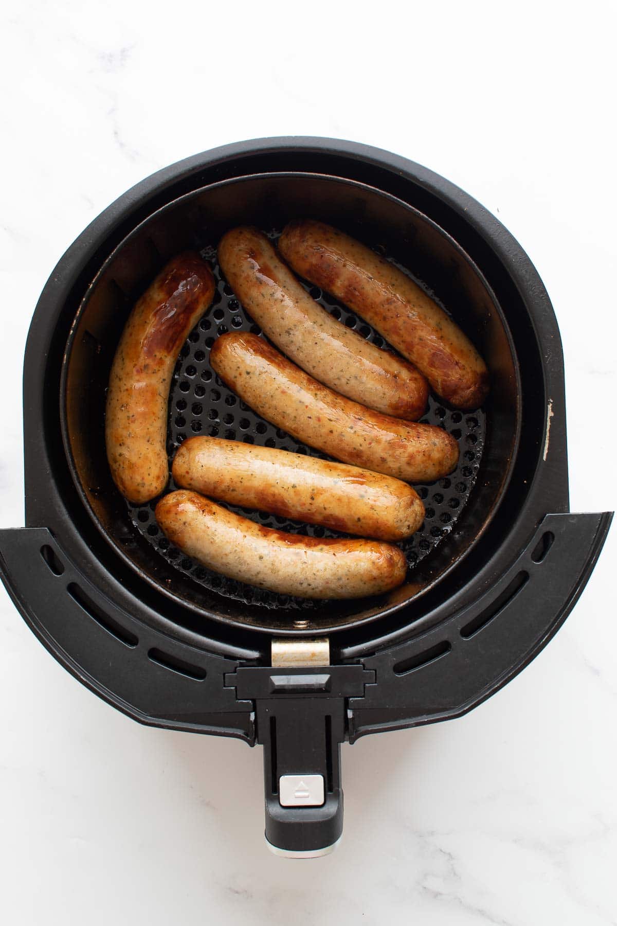 Cooked brats in an air fryer.