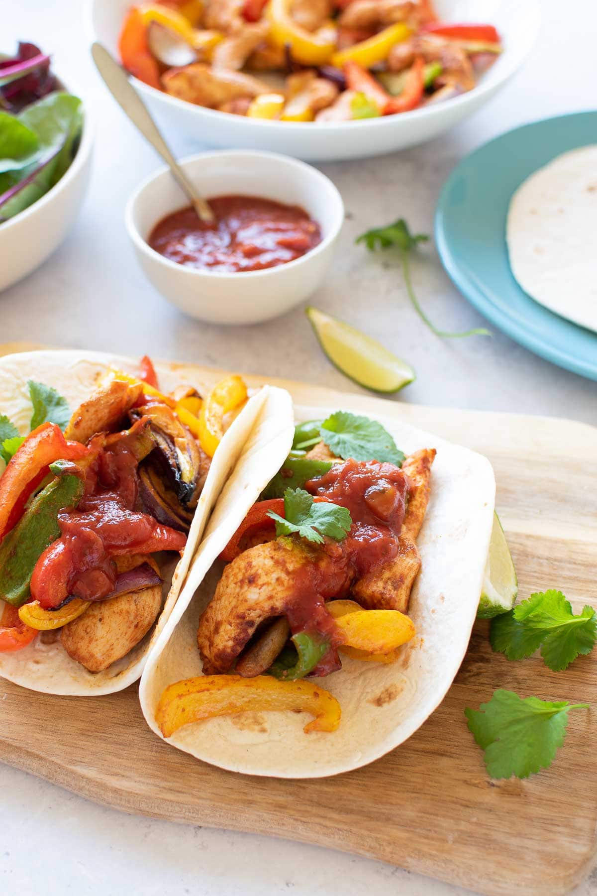 Air fried fajitas with side dishes in the background.