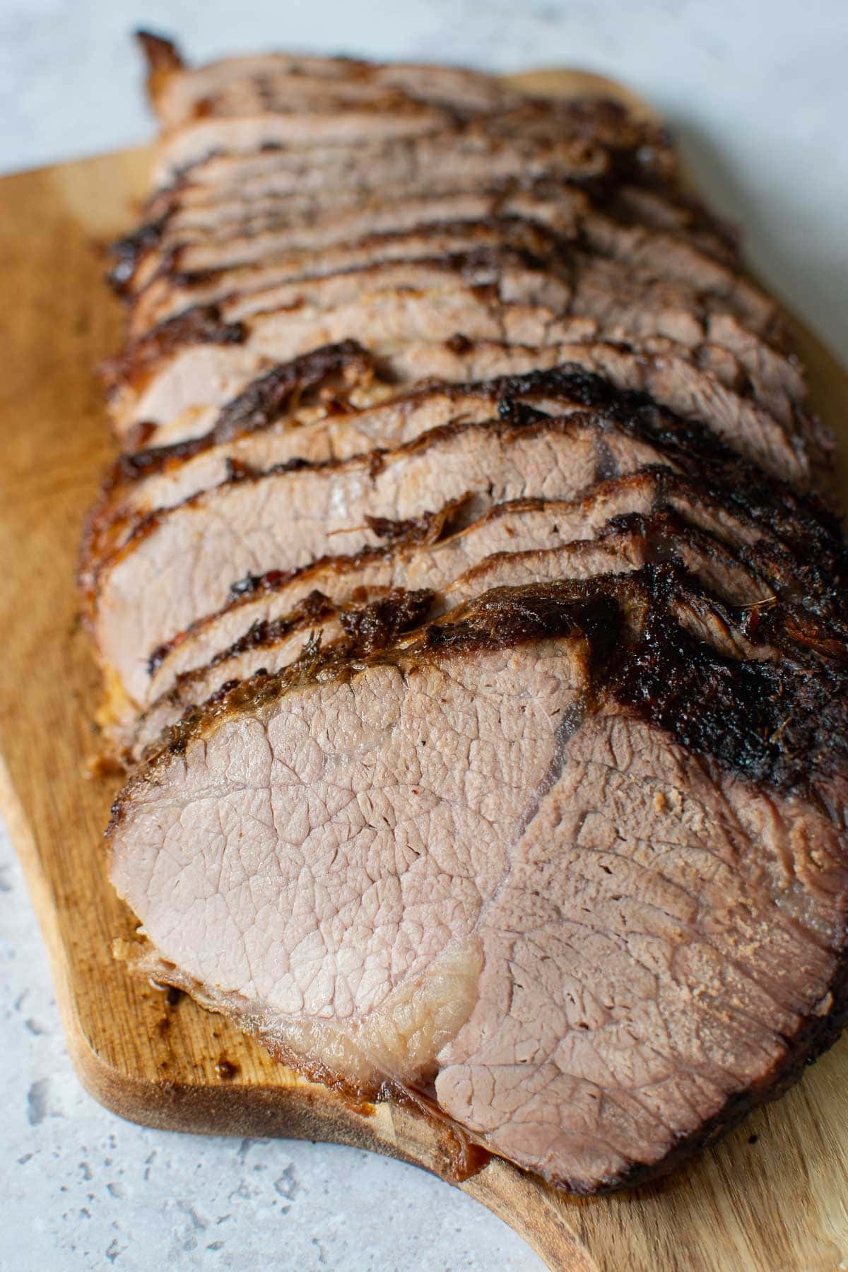 Sliced roast beef on a cutting board.