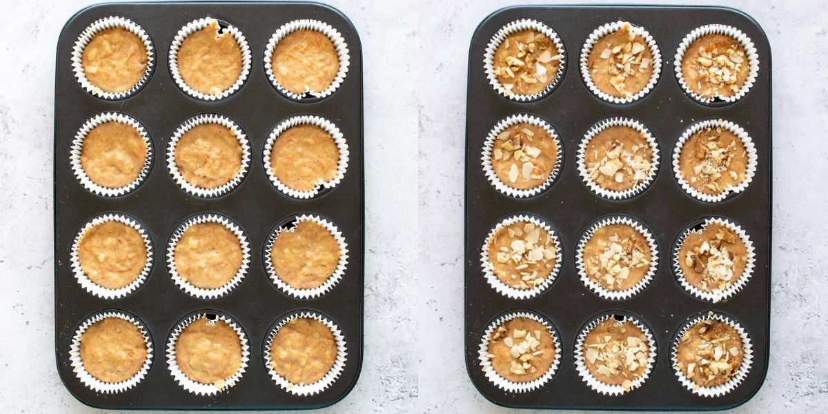 Uncooked muffins in a muffin pan, some topped with diced nuts.