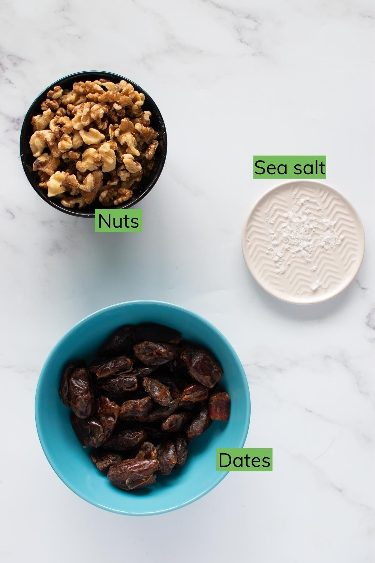 Nuts, dates and sea salt on a table.