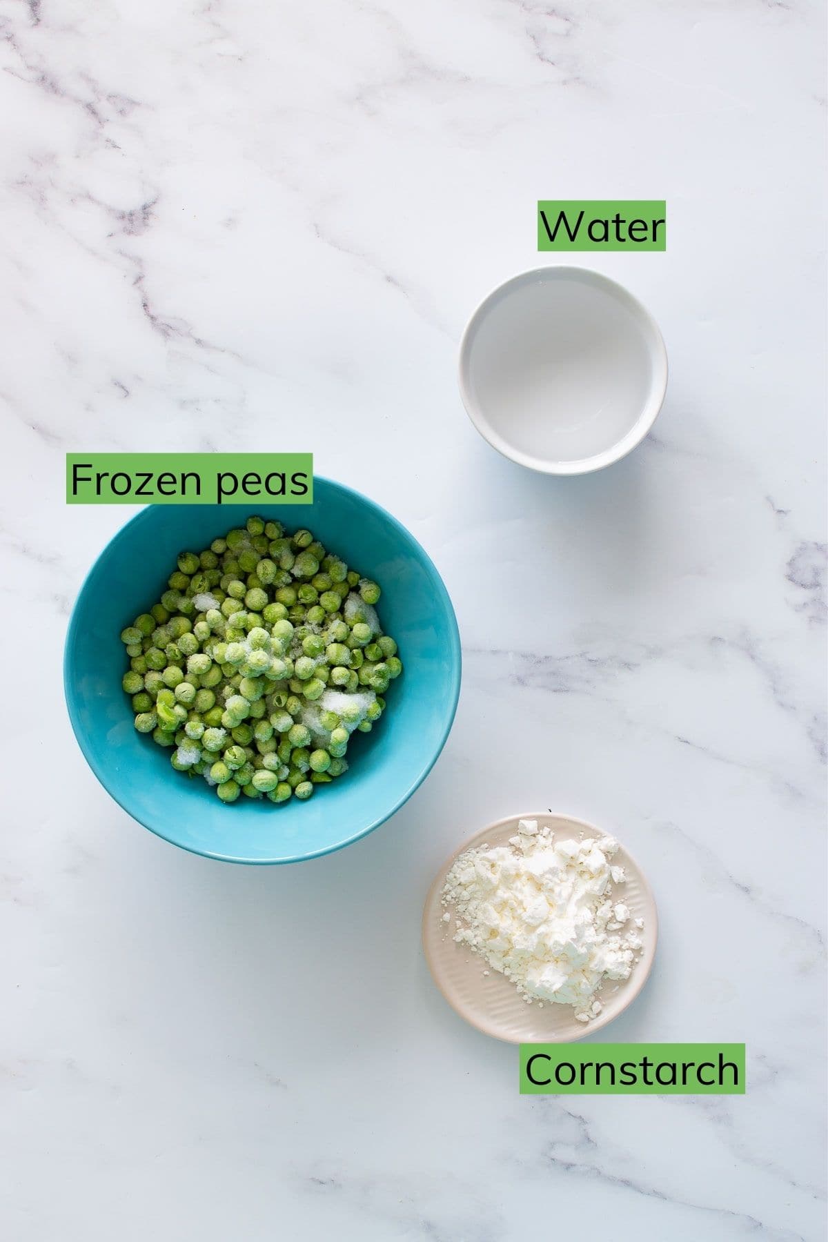 Frozen peas, water and cornstarch on a table.