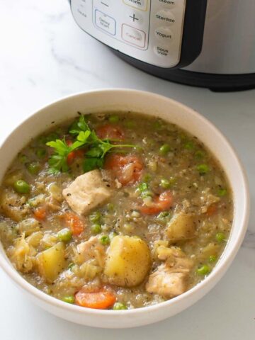 Close up of a bowl of chicken and vegetable stew.